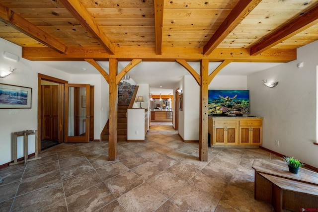 2415 Echo Canyon Ranch Ln, Pagosa Springs, CO 81147 - unfurnished living room with a wooden ceiling with exposed beams, stone finish floors, and stairs