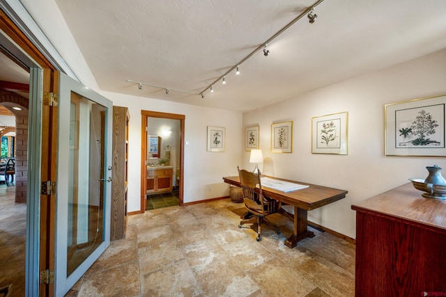 2415 Echo Canyon Ranch Ln, Pagosa Springs, CO 81147 - office with track lighting, stone finish flooring, and french doors