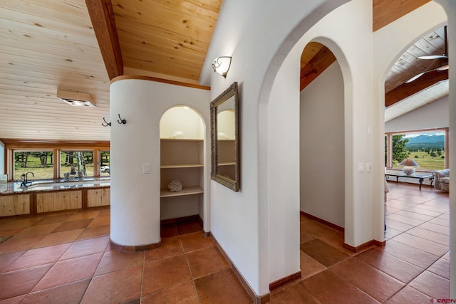 2415 Echo Canyon Ranch Ln, Pagosa Springs, CO 81147 - hall with a wood ceiling with exposed beams, dark tile patterned flooring, arched walkways, and high vaulted ceiling