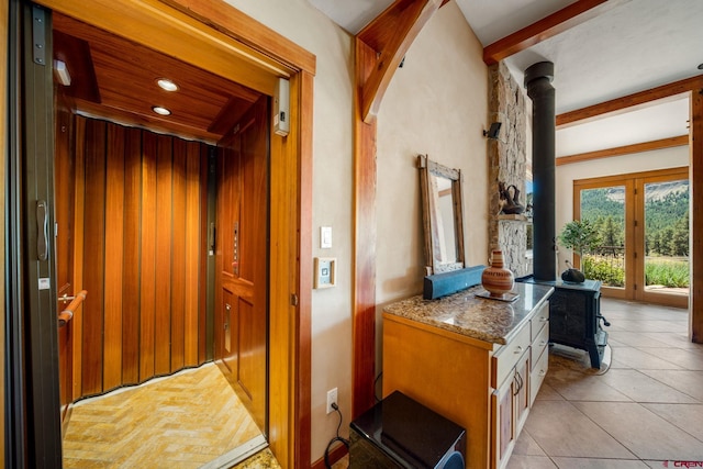 2415 Echo Canyon Ranch Ln, Pagosa Springs, CO 81147 - hallway featuring elevator, light tile patterned flooring, and beam ceiling