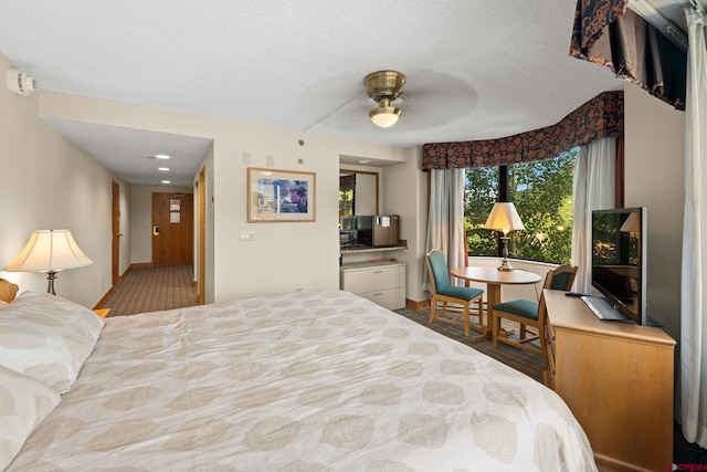 6 Emmons Road 452 & 454, Mount Crested Butte, CO 81225 - bedroom with a textured ceiling and ceiling fan