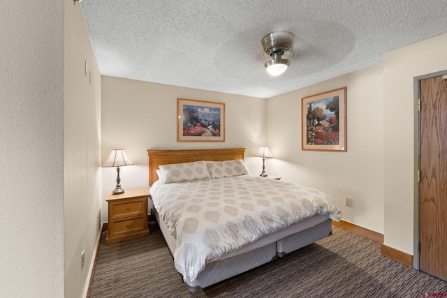 6 Emmons Road 452 & 454, Mount Crested Butte, CO 81225 - bedroom featuring dark carpet, ceiling fan, and a textured ceiling