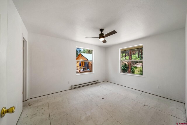 268 Forest Lakes Dr, Bayfield, CO 81122 - empty room with a baseboard radiator and a ceiling fan