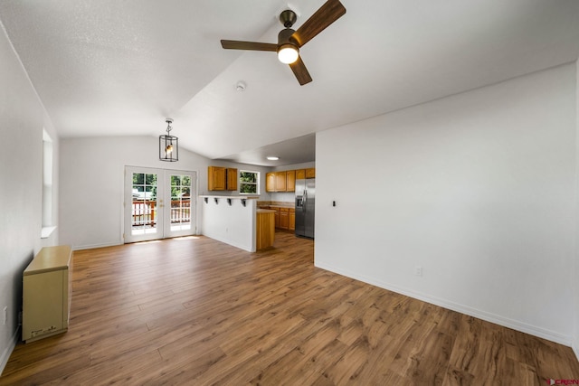 268 Forest Lakes Dr, Bayfield, CO 81122 - unfurnished living room with ceiling fan, vaulted ceiling, wood finished floors, and french doors