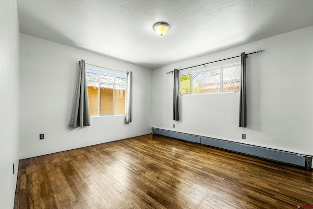 111 E 31st St, Durango, CO 81301 - empty room with baseboard heating and wood-type flooring