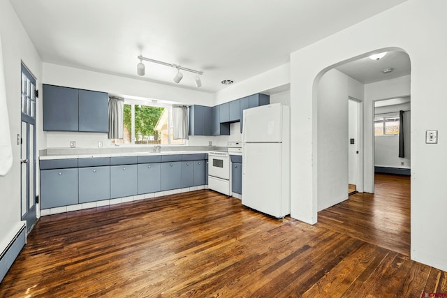 111 E 31st St, Durango, CO 81301 - kitchen featuring white appliances, a baseboard heating unit, arched walkways, dark wood finished floors, and light countertops