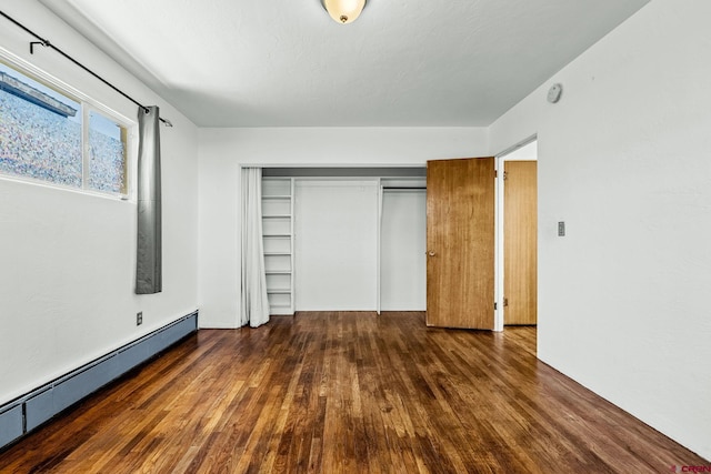 111 E 31st St, Durango, CO 81301 - unfurnished bedroom featuring baseboard heating, wood finished floors, and a closet