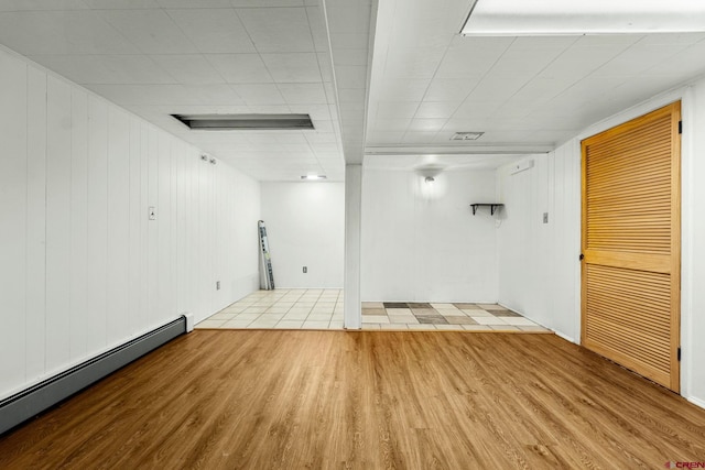111 E 31st St, Durango, CO 81301 - unfurnished room with a baseboard heating unit, wood finished floors, and wooden walls