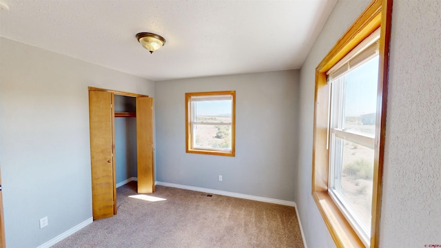 19029 Country Dr, Alamosa, CO 81101 - unfurnished bedroom featuring carpet floors and a closet