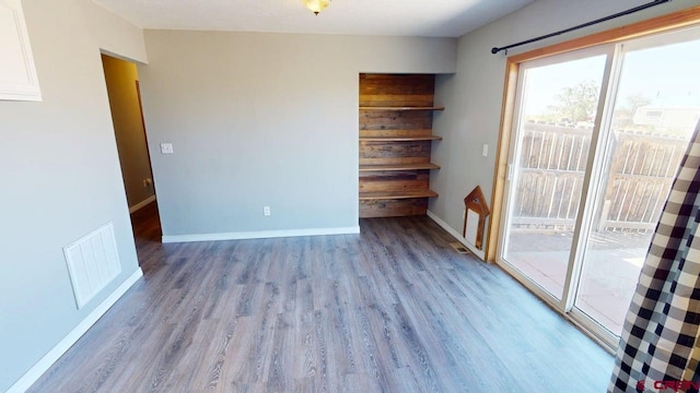 19029 Country Dr, Alamosa, CO 81101 - empty room with wood finished floors and baseboards