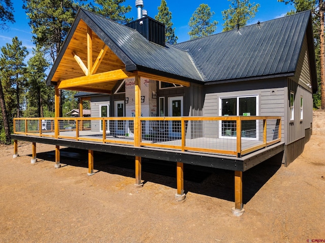 36 Chipmunk Cir, Durango, CO 81301 - rear view of house featuring a deck, a metal roof, board and batten siding, and a chimney