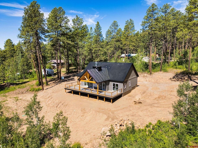 36 Chipmunk Cir, Durango, CO 81301 - back of property featuring dirt driveway, a deck, and a metal roof