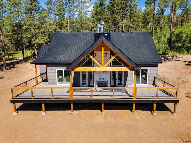 36 Chipmunk Cir, Durango, CO 81301 - rear view of property featuring a wooden deck, a metal roof, and view of scattered trees