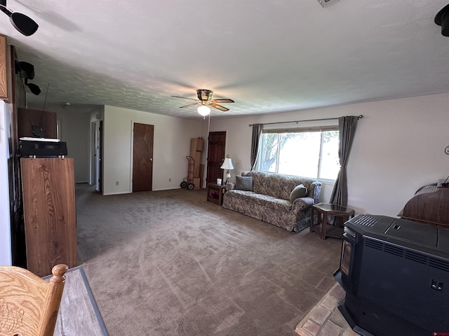 1885 Nichols Way, Montrose, CO 81401 - carpeted living room featuring a ceiling fan and a wood stove