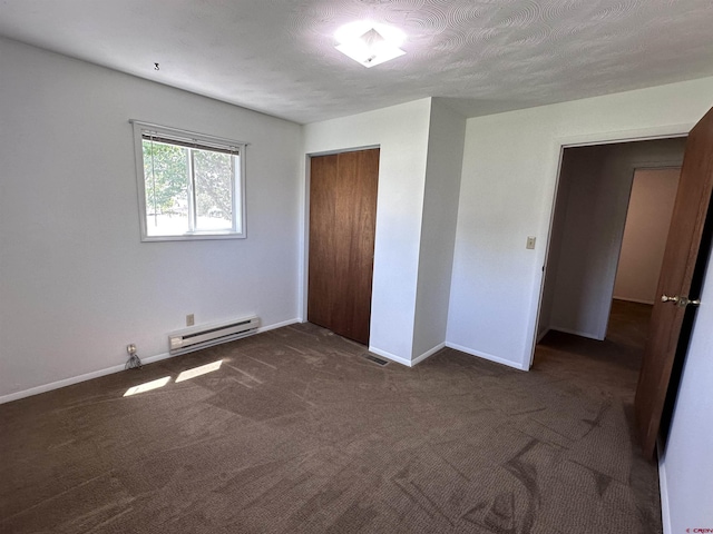 1885 Nichols Way, Montrose, CO 81401 - unfurnished bedroom with a baseboard radiator, dark colored carpet, and a closet
