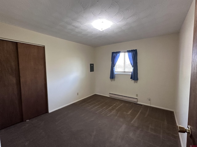 1885 Nichols Way, Montrose, CO 81401 - unfurnished bedroom featuring a baseboard radiator, carpet, a closet, and electric panel