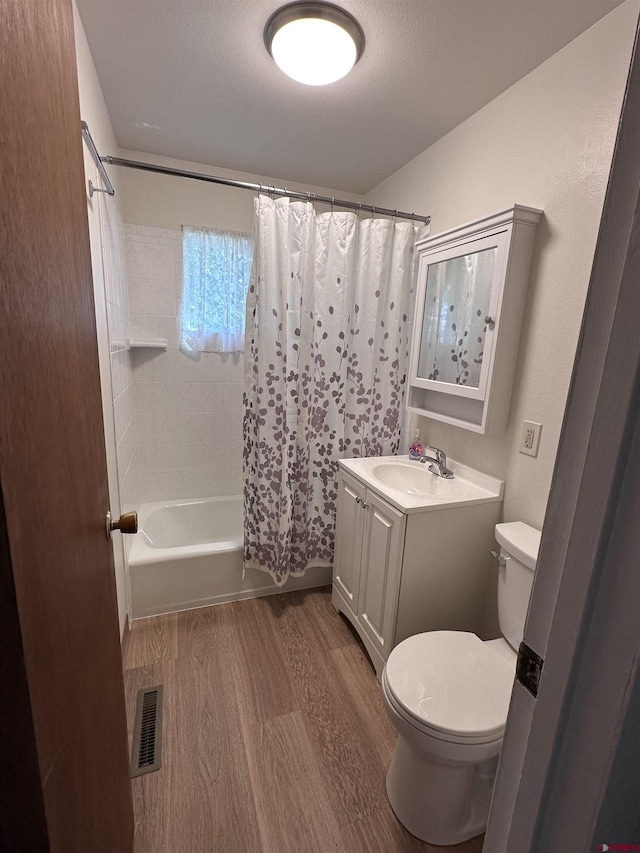 1885 Nichols Way, Montrose, CO 81401 - full bathroom featuring wood finished floors, vanity, and shower / bath combo