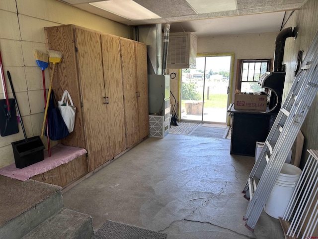 1885 Nichols Way, Montrose, CO 81401 - interior space with unfinished concrete flooring and a wood stove
