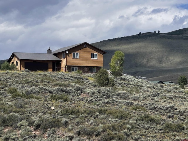 431 Antelope Rd, Gunnison, CO 81230 - rear view of property with a chimney and an outdoor structure