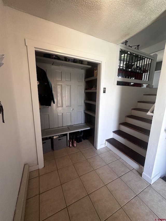 431 Antelope Rd, Gunnison, CO 81230 - mudroom with baseboard heating, a textured ceiling, and tile patterned floors