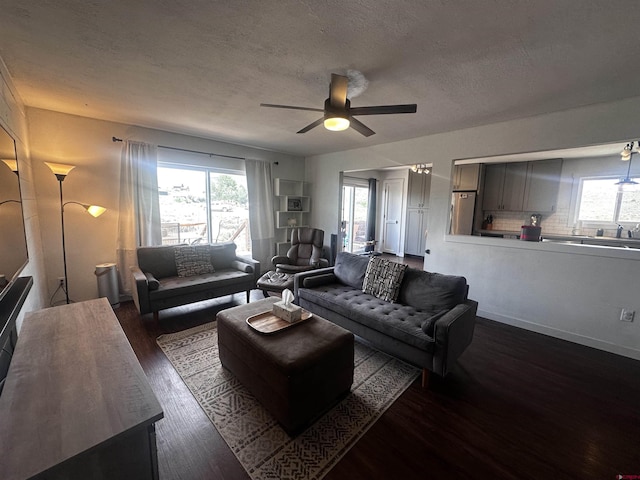431 Antelope Rd, Gunnison, CO 81230 - living room featuring ceiling fan, dark wood-type flooring, plenty of natural light, and a textured ceiling