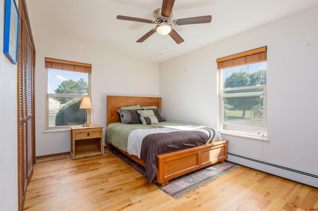 2909 Pheasant Run St, Grand Junction, CO 81506 - bedroom featuring baseboard heating, multiple windows, and light wood finished floors