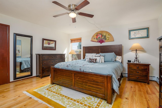 2909 Pheasant Run St, Grand Junction, CO 81506 - bedroom featuring light wood finished floors, a baseboard heating unit, and a ceiling fan