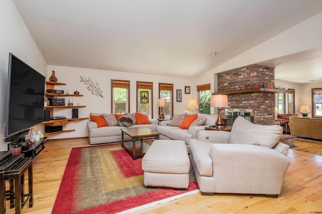 2909 Pheasant Run St, Grand Junction, CO 81506 - living area with healthy amount of natural light, wood finished floors, a fireplace, and lofted ceiling