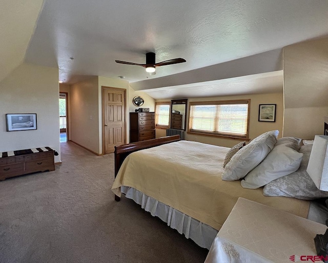 18173 Rd 22, Cortez, CO 81321 - bedroom featuring carpet floors, multiple windows, vaulted ceiling, and ceiling fan