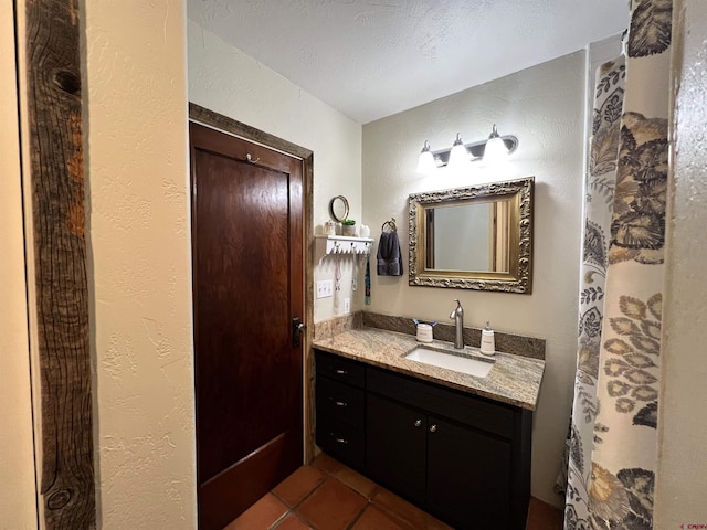 18173 Rd 22, Cortez, CO 81321 - bathroom with vanity, tile patterned flooring, and a textured wall