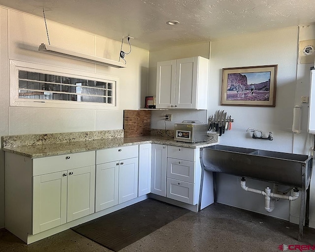18173 Rd 22, Cortez, CO 81321 - kitchen with light stone counters and white cabinetry