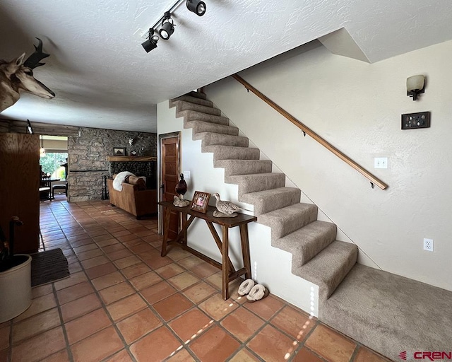 18173 Rd 22, Cortez, CO 81321 - stairway with rail lighting, a textured ceiling, and tile patterned flooring