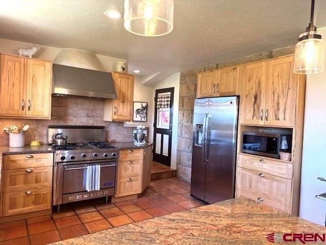 18173 Rd 22, Cortez, CO 81321 - kitchen featuring stainless steel appliances, wall chimney exhaust hood, tile patterned floors, decorative backsplash, and a textured ceiling