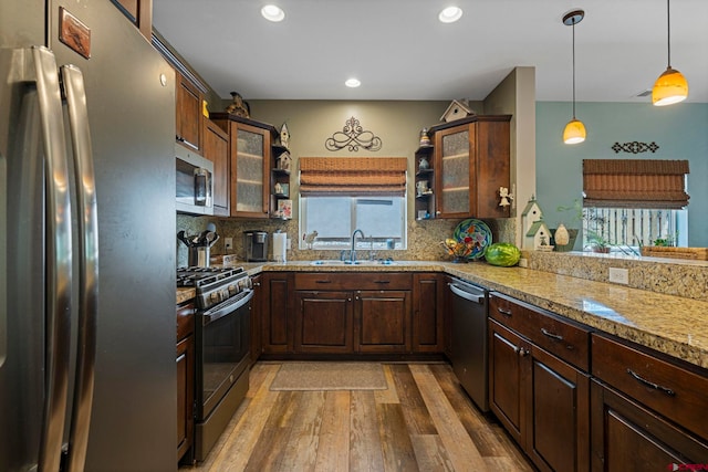21 Tierra Verde Dr, Durango, CO 81301 - kitchen featuring stainless steel appliances, light wood-type flooring, decorative backsplash, hanging light fixtures, and recessed lighting