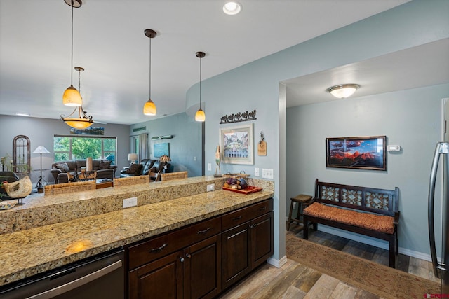 21 Tierra Verde Dr, Durango, CO 81301 - kitchen featuring light wood-style floors, dark brown cabinetry, decorative light fixtures, stainless steel dishwasher, and light stone countertops