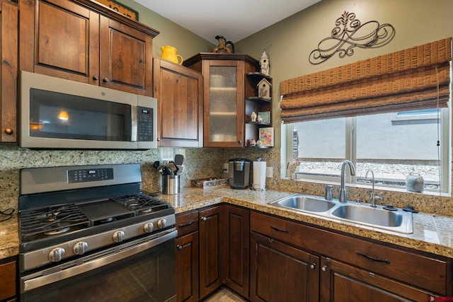 21 Tierra Verde Dr, Durango, CO 81301 - kitchen with stainless steel appliances, glass insert cabinets, backsplash, open shelves, and dark brown cabinetry