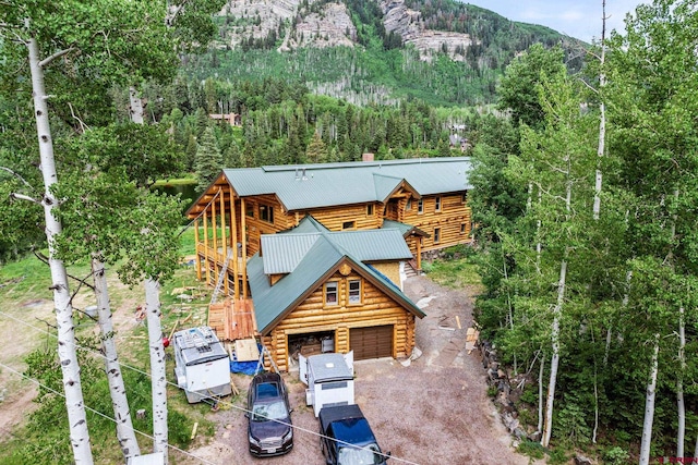 580 Lake Purgatory Dr, Durango, CO 81301 - view of front of property featuring log exterior, driveway, a mountain view, a garage, and a metal roof