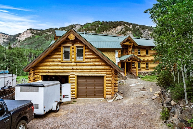 580 Lake Purgatory Dr, Durango, CO 81301 - log-style house with log siding, a mountain view, driveway, and a metal roof