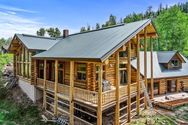 580 Lake Purgatory Dr, Durango, CO 81301 - back of house featuring log exterior, a chimney, a deck, and a metal roof