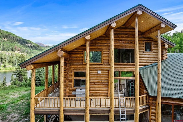 580 Lake Purgatory Dr, Durango, CO 81301 - back of house with log exterior and a deck with water view