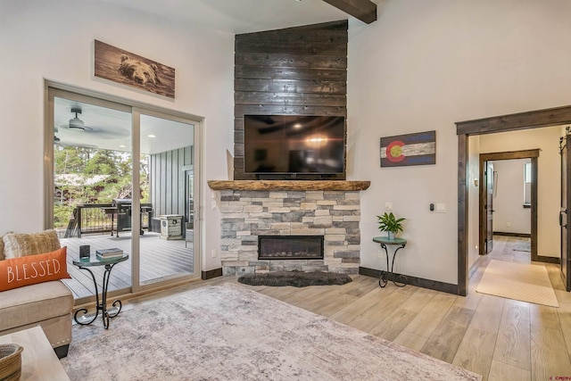 791 Antelope Ave, Pagosa Springs, CO 81147 - living room with a high ceiling, wood finished floors, and a stone fireplace