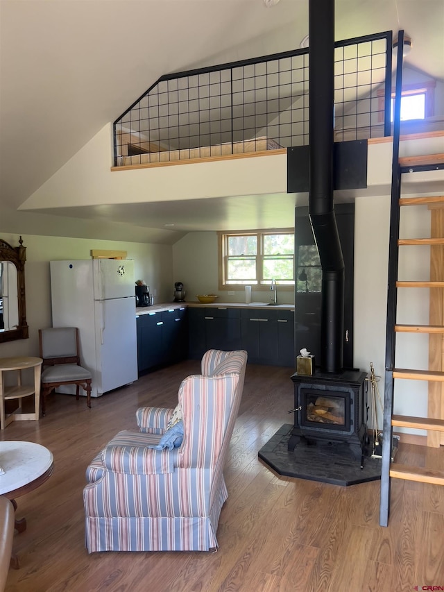 515 Bristol Rd, Placerville, CO 81430 - living room with wood finished floors, a wood stove, and high vaulted ceiling