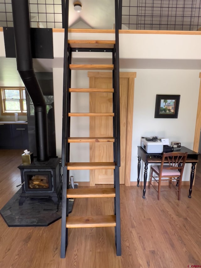 515 Bristol Rd, Placerville, CO 81430 - staircase featuring a wood stove and wood finished floors