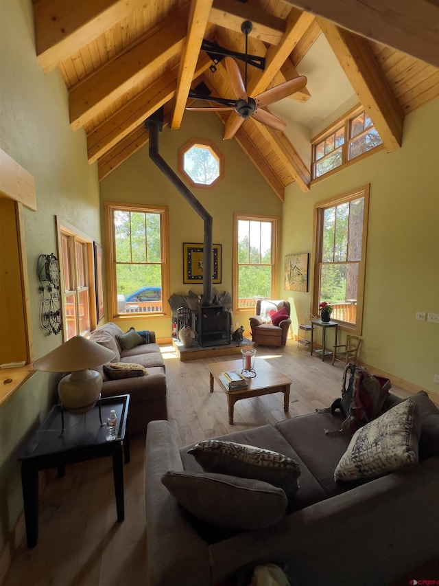 515 Bristol Rd, Placerville, CO 81430 - living room with a wood stove, ceiling fan, wood finished floors, high vaulted ceiling, and a wood ceiling with exposed beams