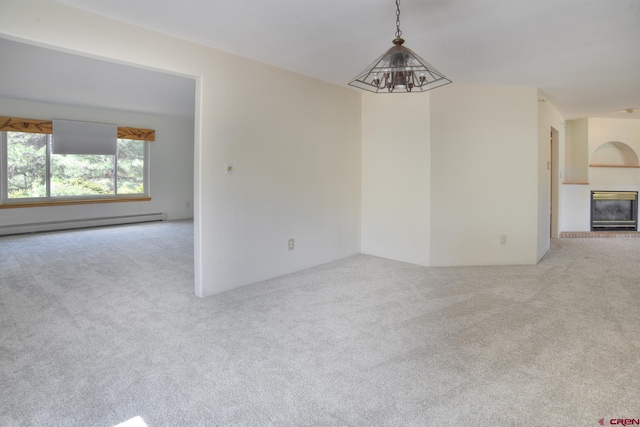 678 N Lakeside Dr, Durango, CO 81303 - carpeted empty room featuring baseboard heating and a brick fireplace