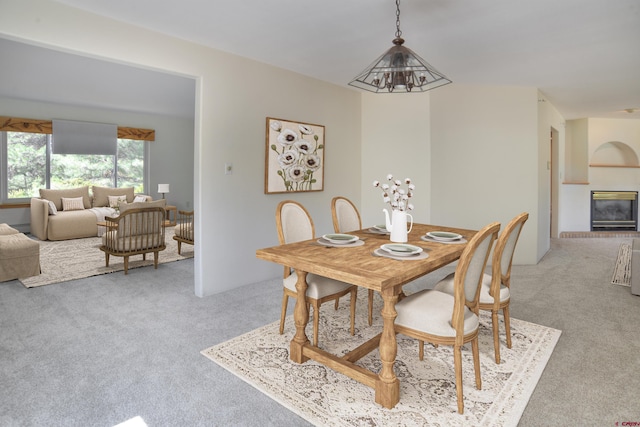 678 N Lakeside Dr, Durango, CO 81303 - dining area featuring light carpet, a glass covered fireplace, and a baseboard radiator
