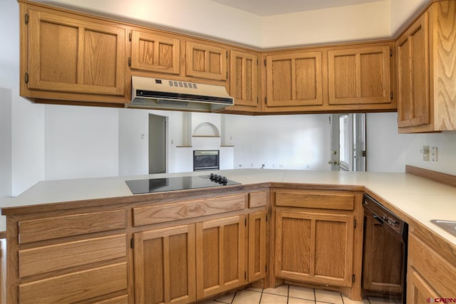 678 N Lakeside Dr, Durango, CO 81303 - kitchen with under cabinet range hood, black appliances, light countertops, light tile patterned floors, and brown cabinetry