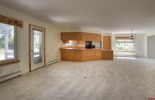 678 N Lakeside Dr, Durango, CO 81303 - kitchen featuring baseboard heating, black microwave, a peninsula, stainless steel fridge, and brown cabinetry