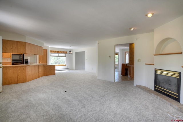 678 N Lakeside Dr, Durango, CO 81303 - unfurnished living room featuring a glass covered fireplace and light colored carpet