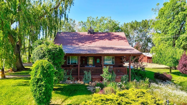 27126 Road R, Dolores, CO 81323 - cabin with covered porch, a front yard, and log exterior